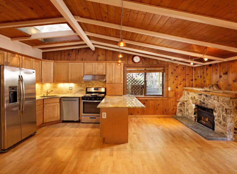 This charming home features a beautiful kitchen with wood cabinets and granite countertops, complemented by stainless steel appliances.