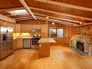 This charming home features a beautiful kitchen with wood cabinets and granite countertops, complemented by stainless steel appliances.