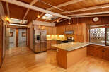 This charming kitchen boasts a vaulted wood ceiling with skylights, creating a bright and airy atmosphere.