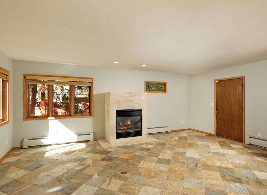 This stunning property boasts a spacious living area with a cozy fireplace, perfect for relaxing evenings.