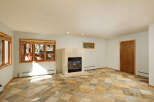This stunning property boasts a spacious living area with a cozy fireplace, perfect for relaxing evenings.