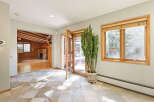 This stunning home boasts a spacious sunlit interior with hardwood floors and a cozy stone fireplace.