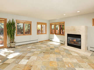 This stunning property boasts a spacious living area with large windows that offer abundant natural light and views of the surrounding landscape.