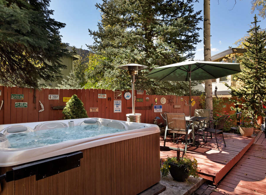 Relax and unwind in your private hot tub, nestled in a charming backyard setting.