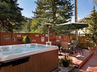 Relax and unwind in your private hot tub, nestled in a charming backyard setting.