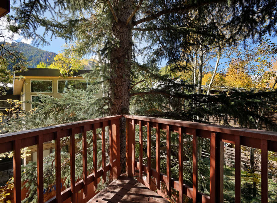 Enjoy breathtaking mountain views from this charming deck, nestled amongst towering trees.