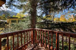 Enjoy breathtaking mountain views from this charming deck, nestled amongst towering trees.