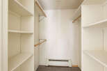 Spacious closet with ample shelving and hanging rods, providing convenient storage solutions.