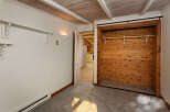 Cozy bedroom with built-in closet featuring wood paneling and a sliding door.