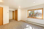 Spacious room with neutral walls and carpet flooring.