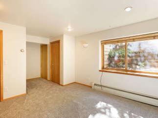Spacious room with neutral walls and carpet flooring.