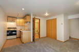 Cozy basement apartment with a kitchenette, full bathroom, and ample closet space.