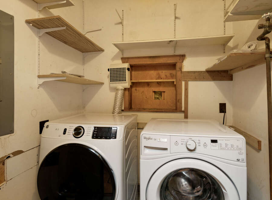 This laundry room features a stackable washer and dryer set, providing convenient in-unit laundry facilities.