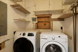 This laundry room features a stackable washer and dryer set, providing convenient in-unit laundry facilities.