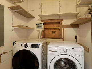 This laundry room features a stackable washer and dryer set, providing convenient in-unit laundry facilities.