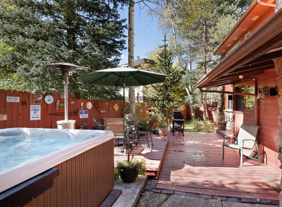 Relax and enjoy the mountain views from this charming property's private deck, complete with a hot tub and patio furniture.
