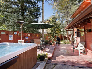 Relax and enjoy the mountain views from this charming property's private deck, complete with a hot tub and patio furniture.