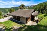 Discover a charming chalet nestled in a picturesque mountain setting.