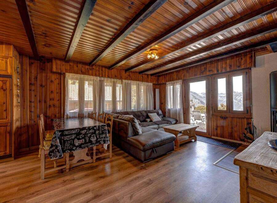Experience the warmth of this cozy cabin with its inviting wooden interior.