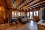 Experience the warmth of this cozy cabin with its inviting wooden interior.