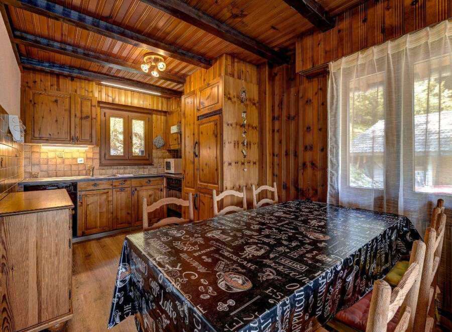 This charming kitchen boasts a warm, inviting atmosphere with its wooden cabinetry and paneling.