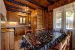 This charming kitchen boasts a warm, inviting atmosphere with its wooden cabinetry and paneling.