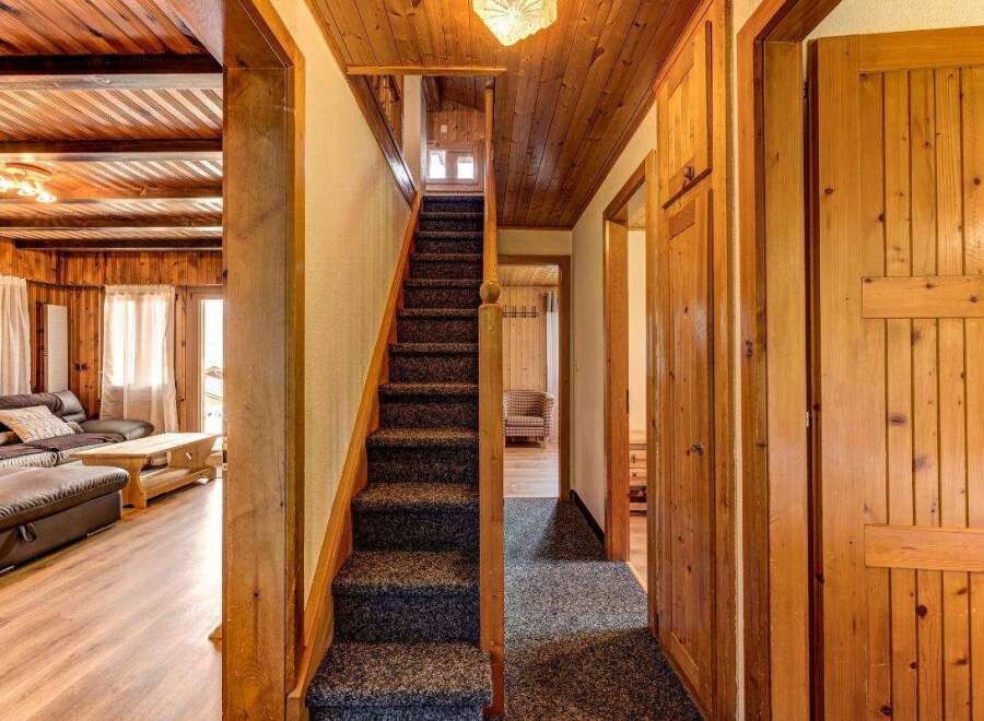 Step into this charming home featuring a cozy interior with wooden accents throughout.