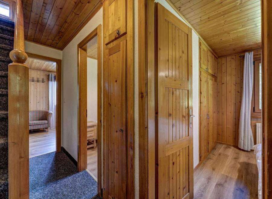 Explore the warm embrace of this inviting home, featuring stunning wooden accents throughout.