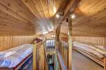Discover the charm of this cozy cabin with its warm wooden interior and inviting atmosphere.