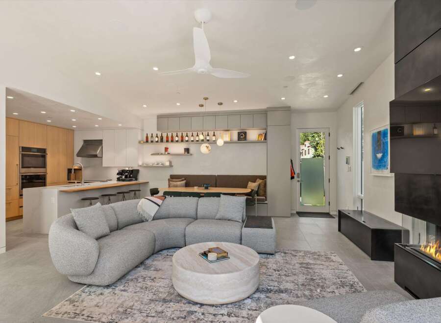 This stunning modern home boasts an open-concept living space seamlessly blending the kitchen, dining, and living areas.