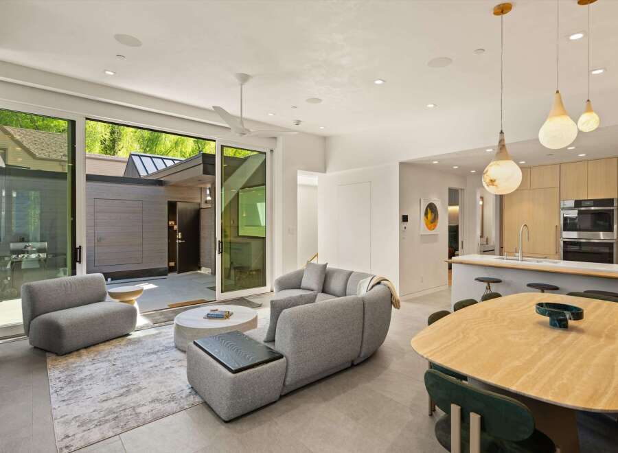 This stunning home boasts an open floor plan, seamlessly connecting the living area to the modern kitchen and dining space.
