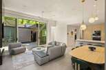 This stunning home boasts an open floor plan, seamlessly connecting the living area to the modern kitchen and dining space.