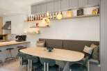 This stunning kitchen boasts a built-in banquette seating area, perfect for intimate dining.