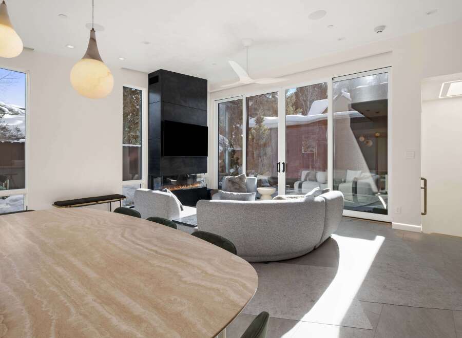 This stunning home boasts an open floor plan with floor-to-ceiling windows offering breathtaking views.