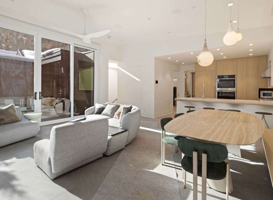 This stunning home boasts an open floor plan with floor-to-ceiling windows offering breathtaking views.