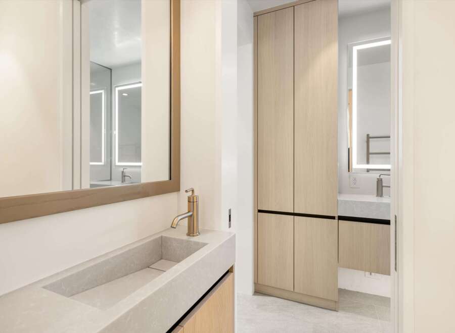 This stunning bathroom boasts a sleek, modern design with a floating concrete sink and a minimalist faucet.