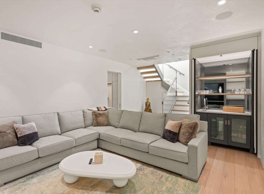 This stunning home boasts a spacious, light-filled living area perfect for relaxation and entertainment.