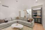 This stunning home boasts a spacious, light-filled living area perfect for relaxation and entertainment.