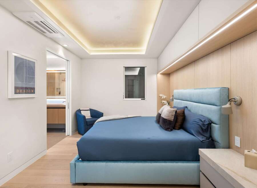 This stunning bedroom boasts a serene atmosphere with its light color palette and modern design.