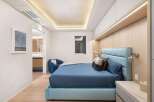 This stunning bedroom boasts a serene atmosphere with its light color palette and modern design.