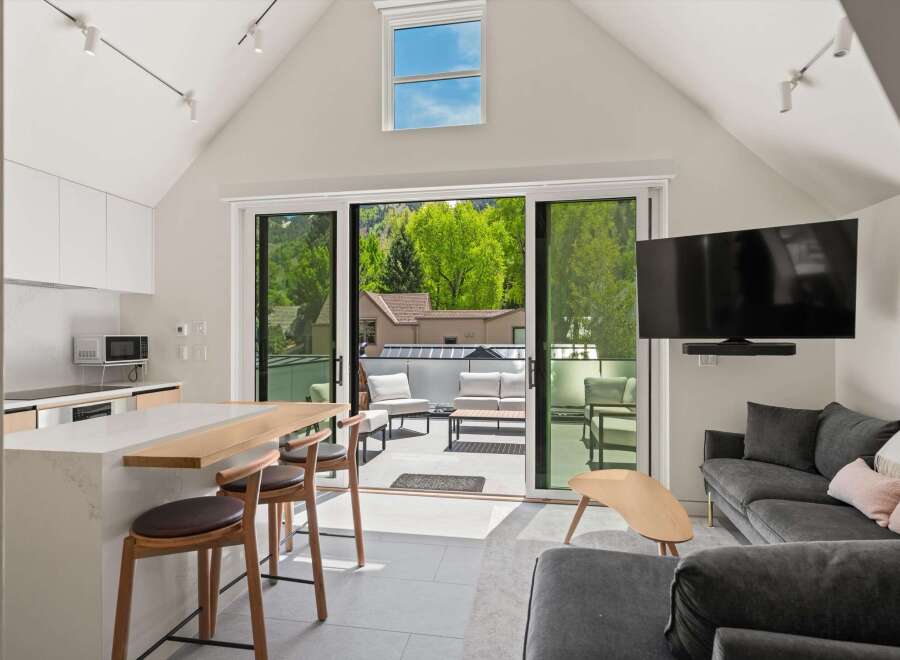 This stunning property boasts a bright, open-concept living space with floor-to-ceiling sliding glass doors that lead to a private outdoor patio.
