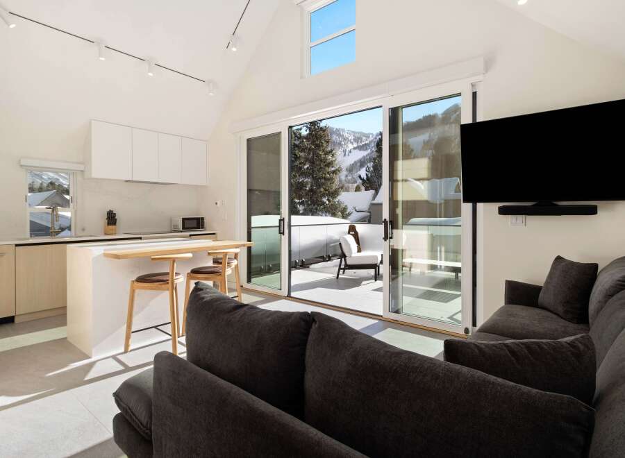This stunning condo boasts a modern, open-concept design with floor-to-ceiling windows offering breathtaking mountain views.