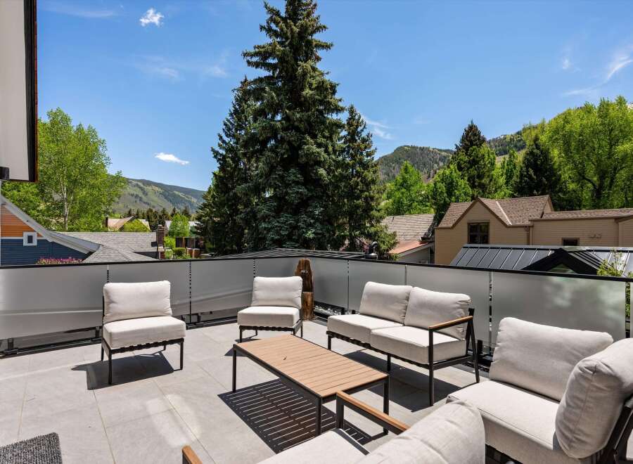 This luxurious property boasts a stunning rooftop deck with breathtaking mountain views.