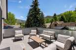This luxurious property boasts a stunning rooftop deck with breathtaking mountain views.