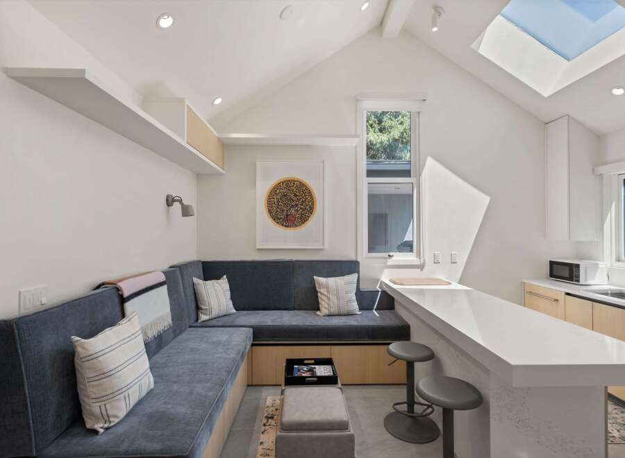 This stunning property boasts a bright, open-concept design with a built-in banquette seating area perfect for relaxing.