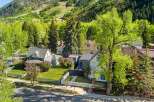 This charming home boasts a picturesque setting nestled in the mountains, offering breathtaking views.