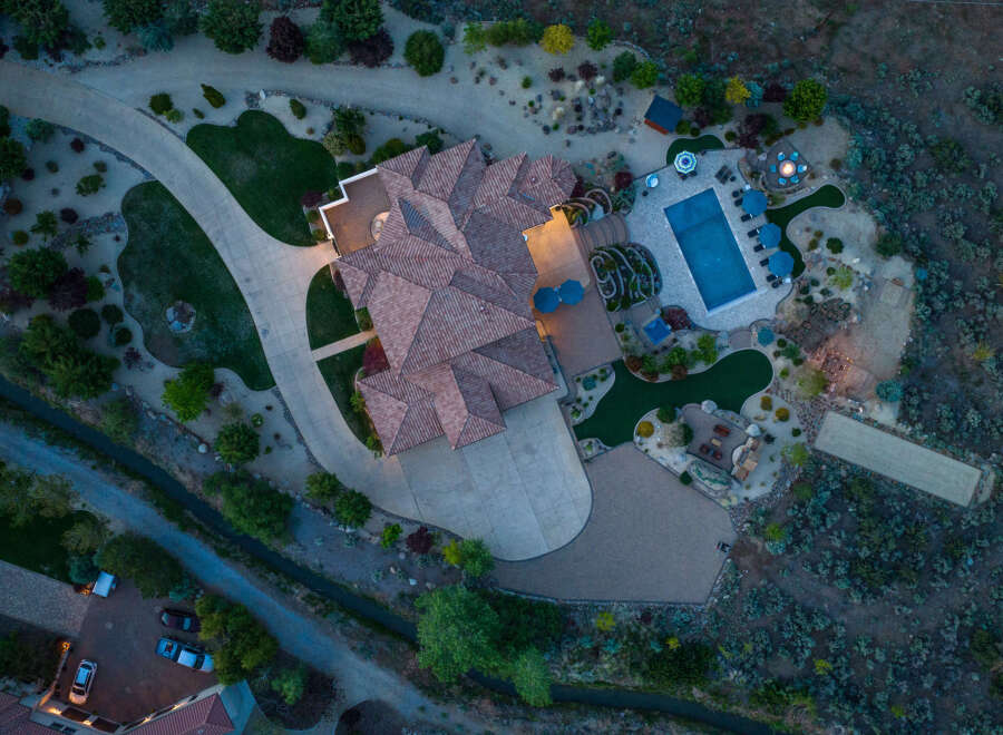 This stunning property boasts a large, inviting pool and expansive patio perfect for outdoor entertaining.