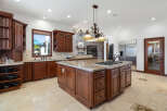 This stunning kitchen boasts a large island with granite countertops and a gas cooktop, perfect for entertaining.