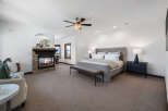 This luxurious bedroom boasts a cozy fireplace, creating a warm and inviting atmosphere.