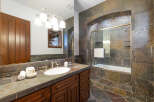 This luxurious bathroom boasts a stunning slate tile design, creating a spa-like atmosphere.